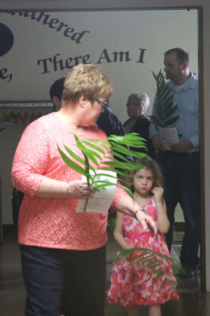 Woman and child with palms in the narthex.